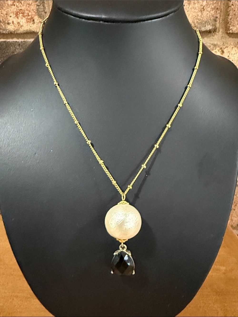 Vintage Artisan gold tone necklace with white and black drop pendant